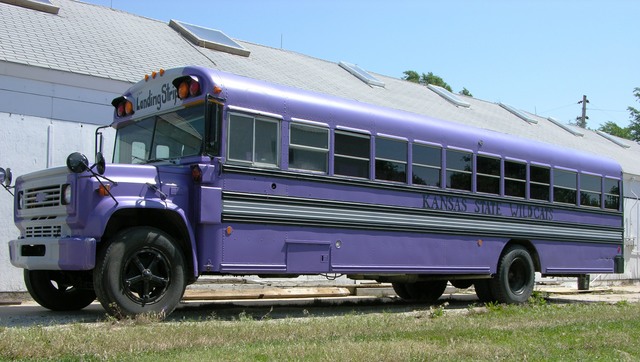 Purple schoolbus, front left profile