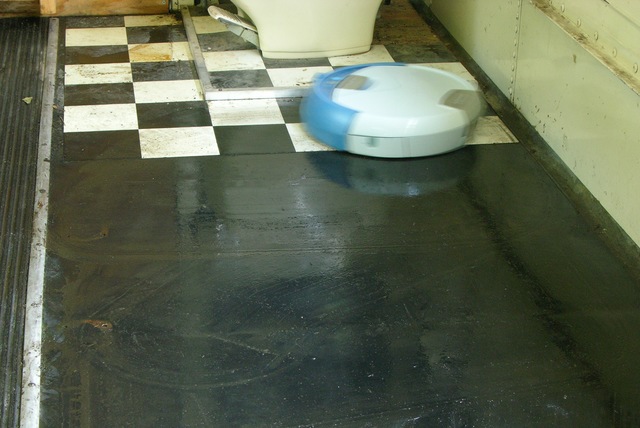 Scooba floor cleaner in aft port area of schoolbus