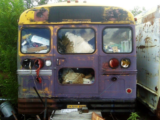 Rear end of Bluebird bus in junkyard