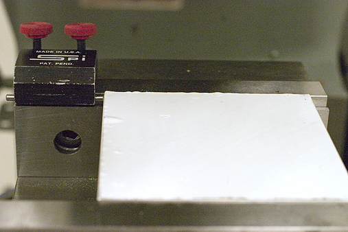 Aluminum plate in vise with stop