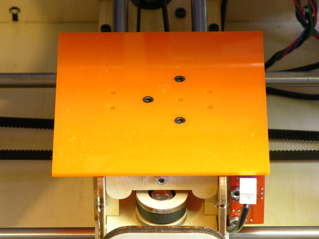 Orange acrylic sub-bed on MakerBot CupCake build stage