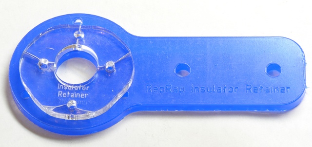 Broken MakerBot CupCake insulator retainer on spare RepRap insulator retainer