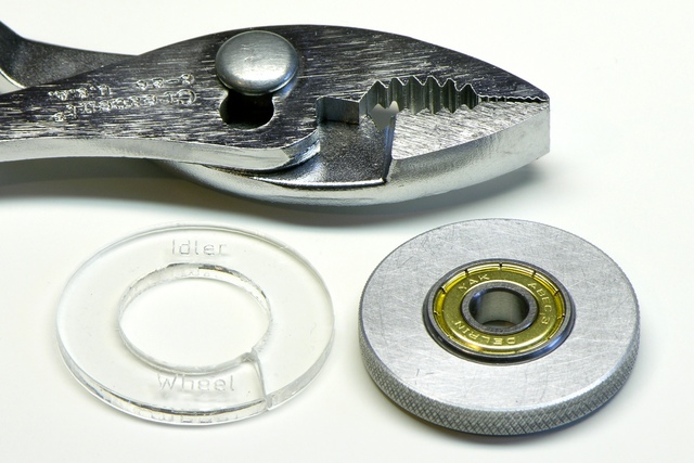 Broken acrylic and replacement aluminum MakerBot CupCake Plastruder idler wheels