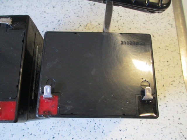 Prying open sealed lead-acid battery cover